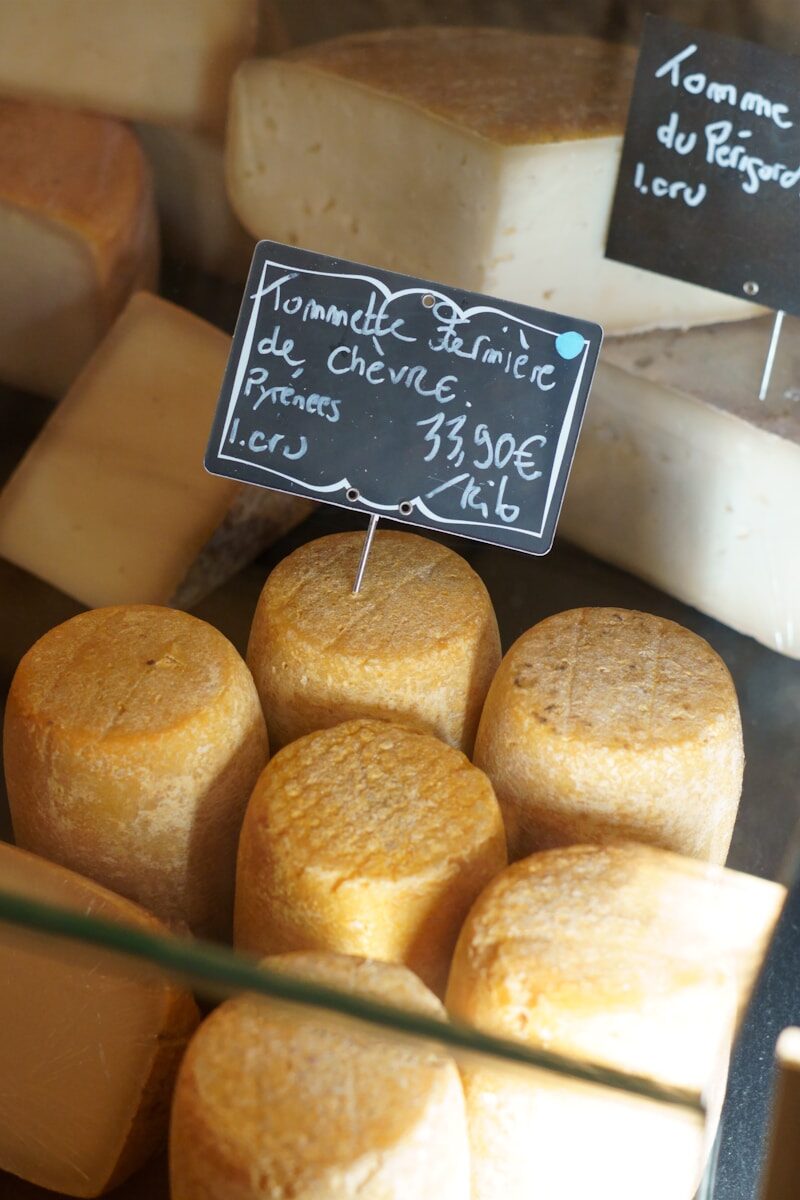 Assortment of artisanal cheeses displayed in a shop.